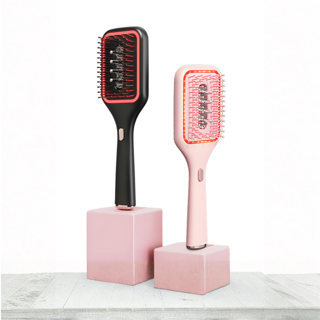 Black and pink hair oil dispensing brushes on pink stands