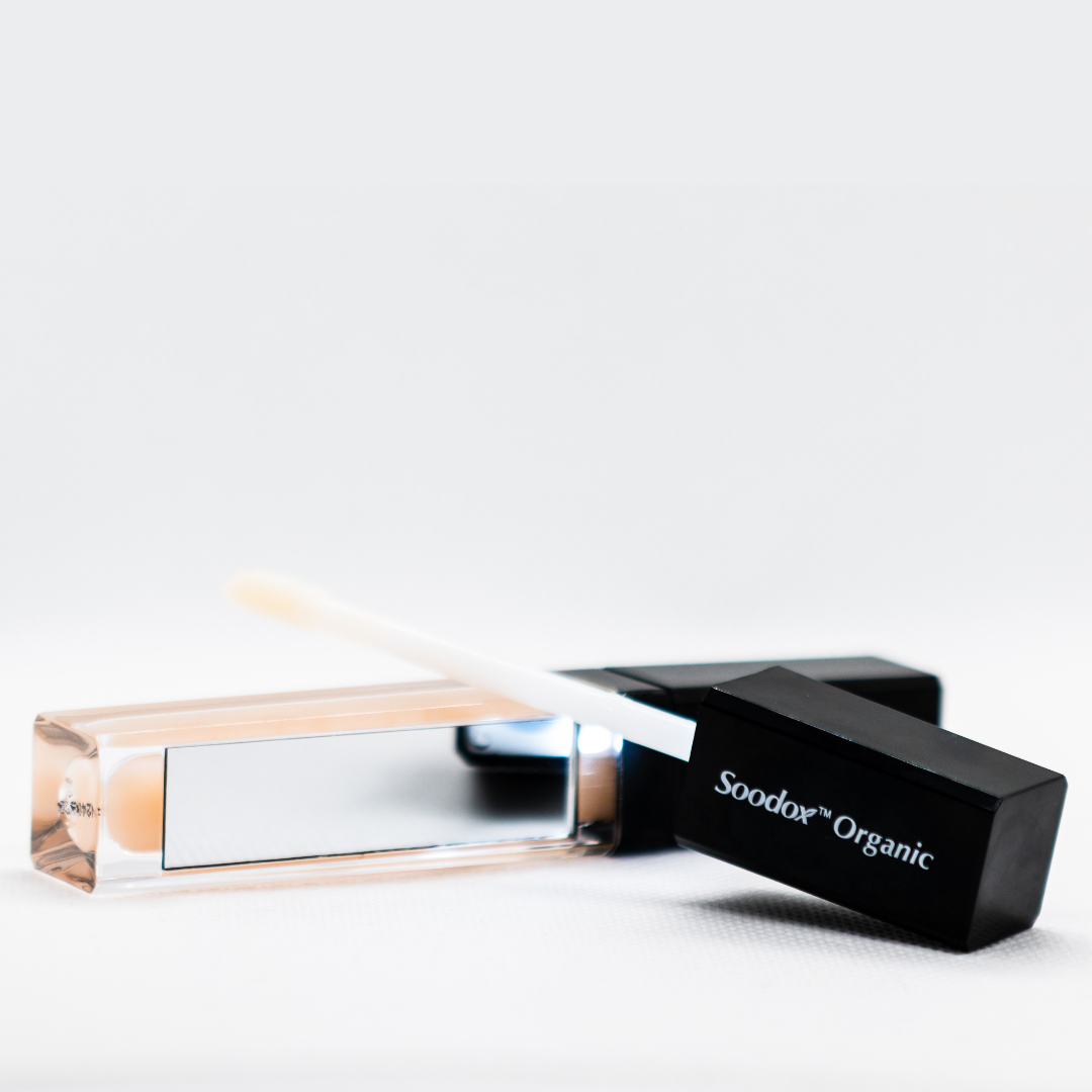 Soodox Organic Plumping Lip Oil tube lying with applicator