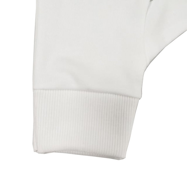 Close-up of ribbed cuff on white cotton glove
