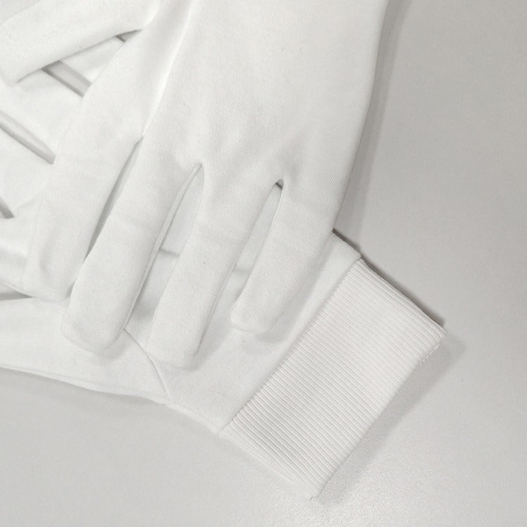 Close-up of white cotton glove cuff