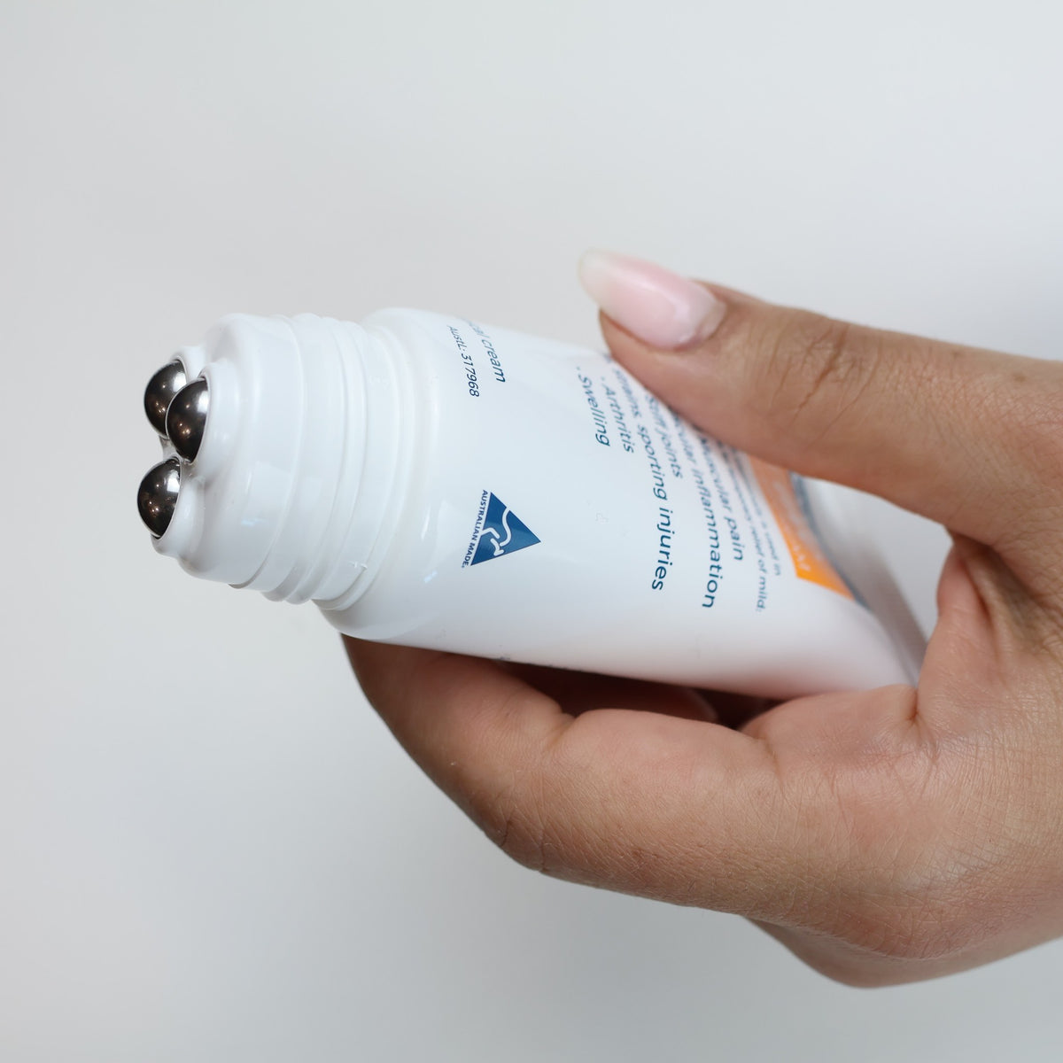 Soodox Active Pain Relief Cream 50g roll-on held in hand
