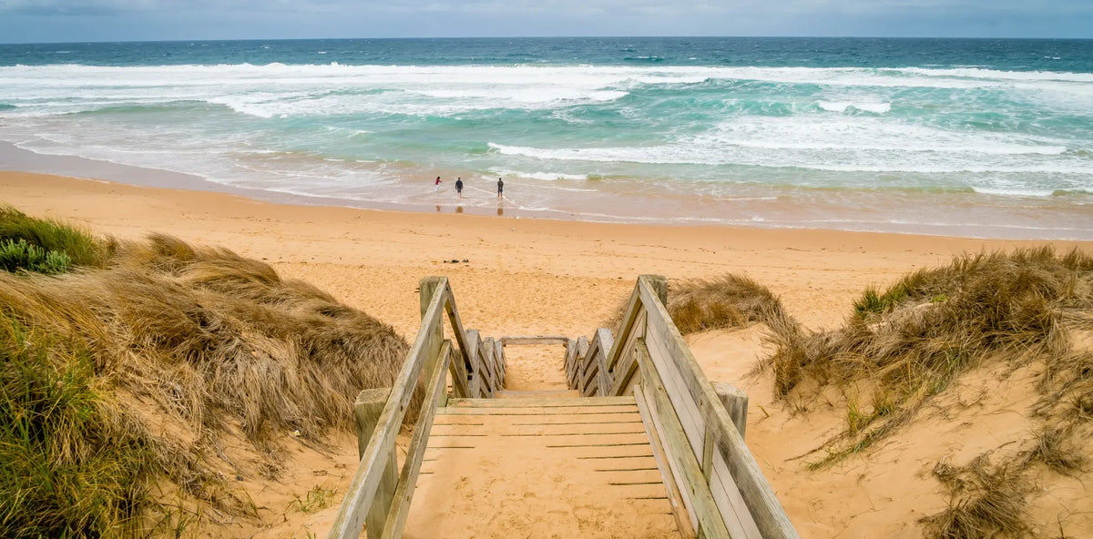Coastal path and wooden stairs leading to the beach