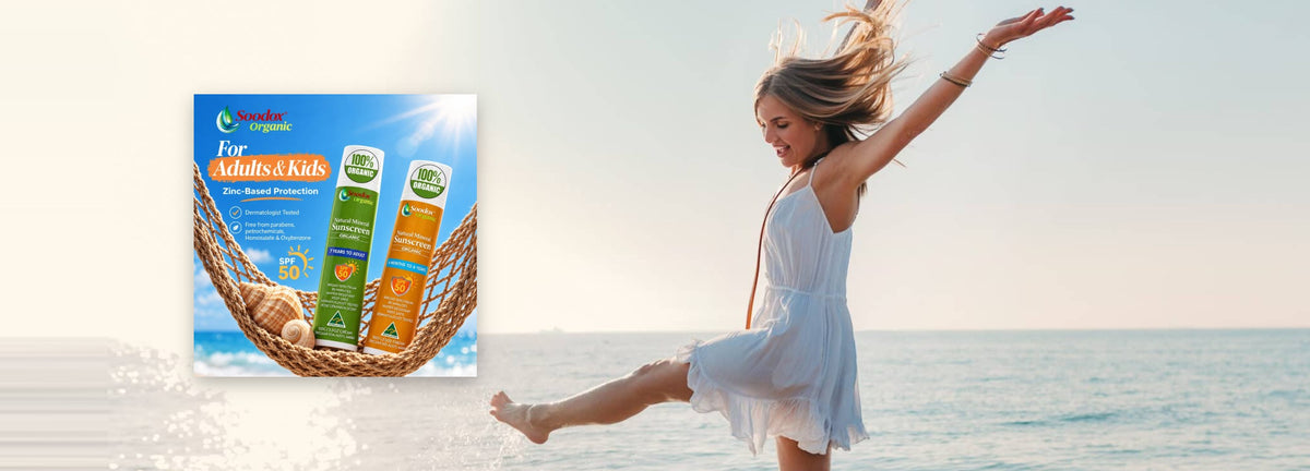 Woman dancing on the beach beside Soodox Organic Natural Mineral Sunscreen for adults and kids
